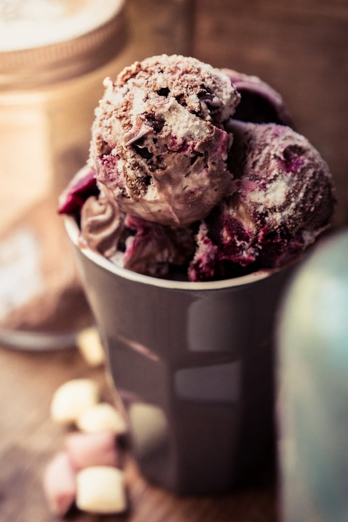 Close-up of berry chocolate ice cream in a cup, showcasing a rich and creamy texture.